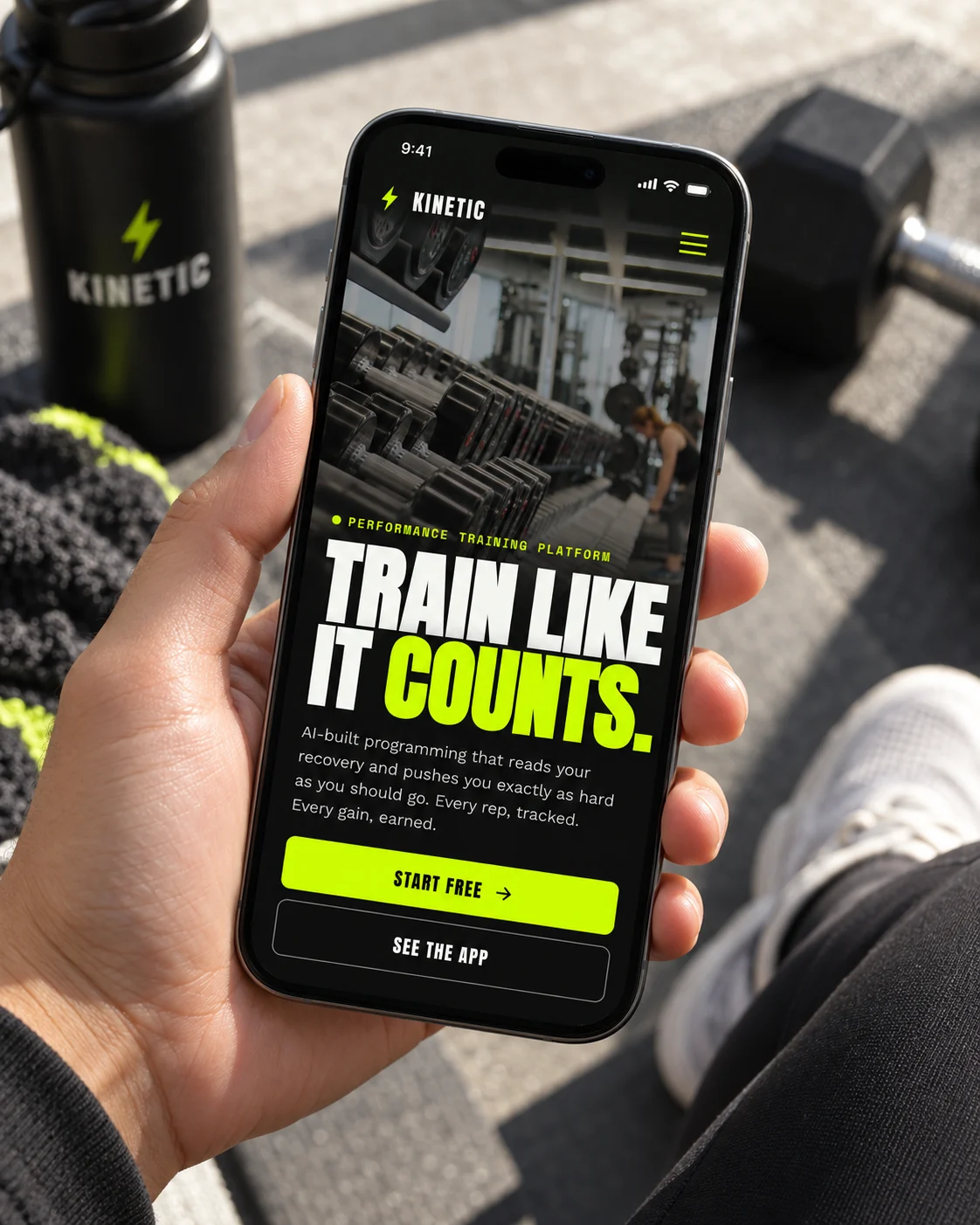 Kinetic's homepage on a phone held in a gym