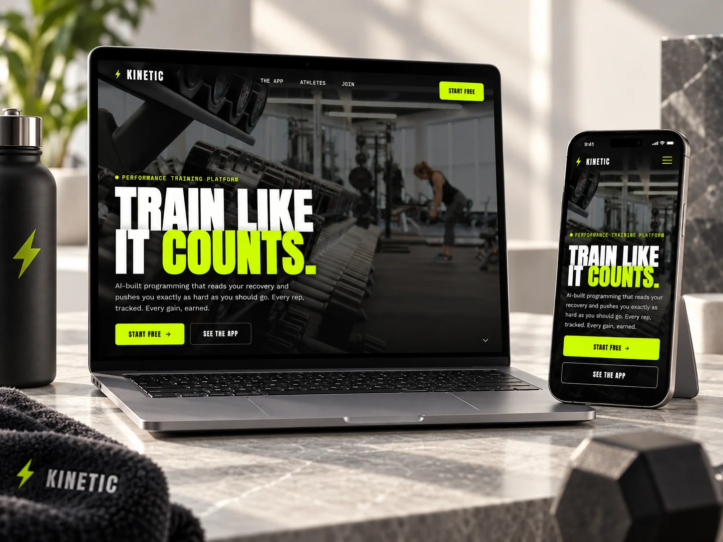 Kinetic's homepage on a laptop and a phone, with a Kinetic towel and a dumbbell