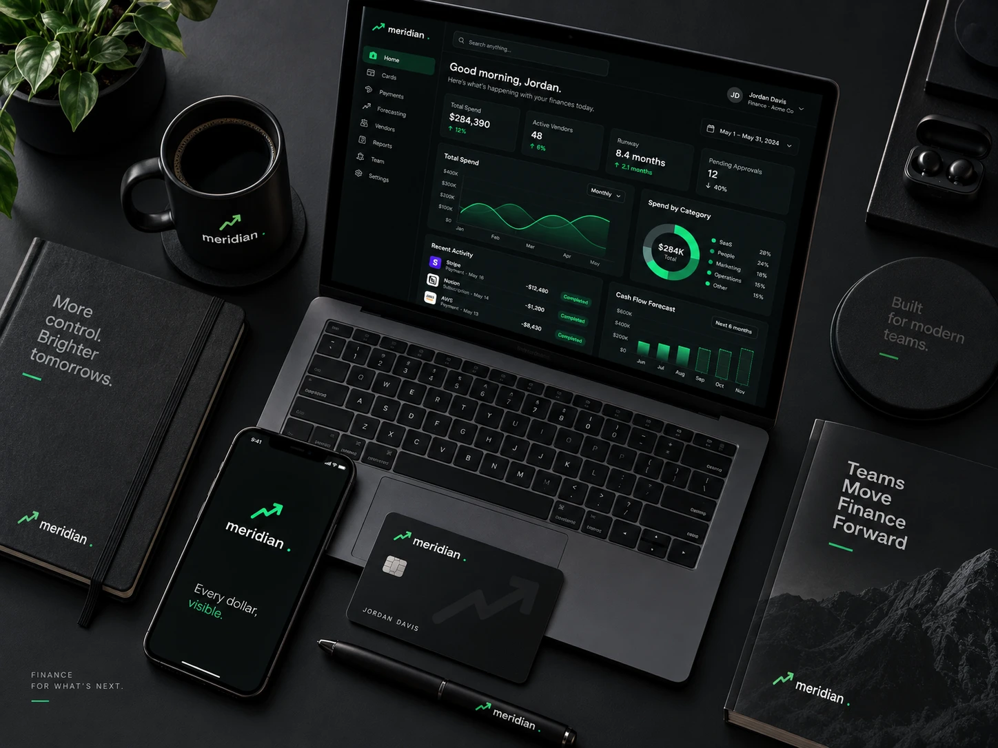 A Meridian card, phone, laptop, notebook and mug