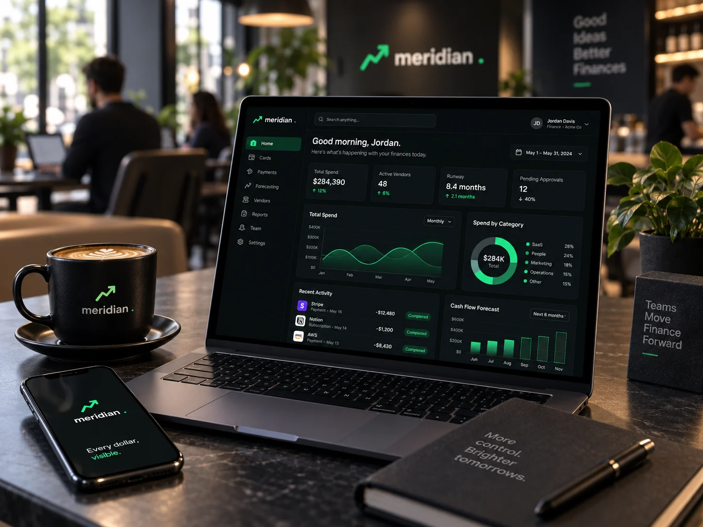 Meridian on a laptop and a phone in a café, with the Meridian logo on the wall behind