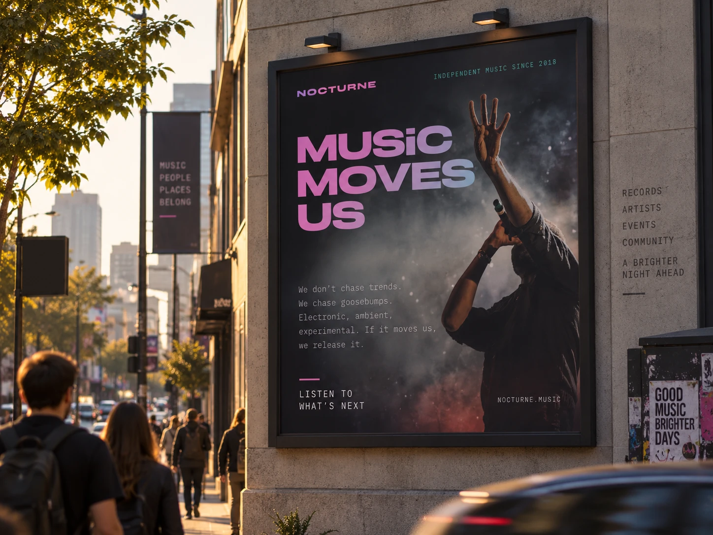 A Nocturne poster reading Music moves us on a city street