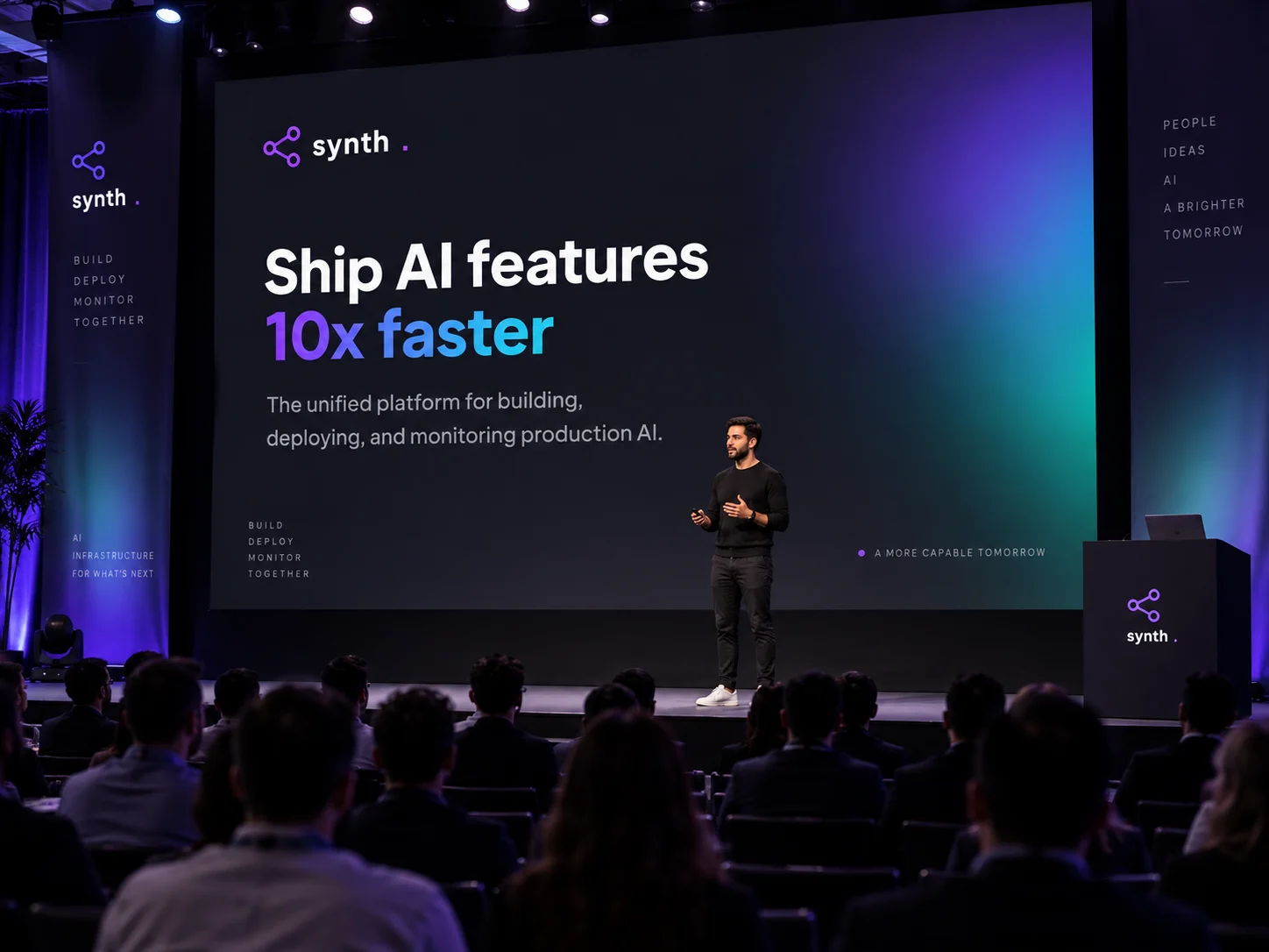 A keynote speaker on stage with Synth's headline on the screen behind